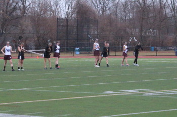 Action during Belmont High School's Grils' Lacrosse's 2014 season opener with Newton North.